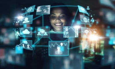 Technology, ai and business woman networking or trading at night using virtual UX interface at work. Female using big data hologram with futuristic 5g network and social connections in dark office.